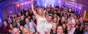 Smiling wedding guests on the dance floor at one of the best of banquets halls in Chicagoland