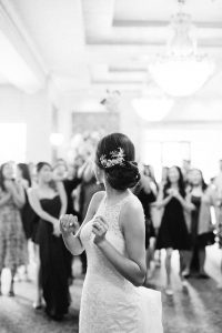 Bouquet toss by the bride in the grand ballroom in Astoria Banquets