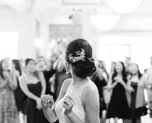 Bouquet toss by the bride in the grand ballroom in Astoria Banquets