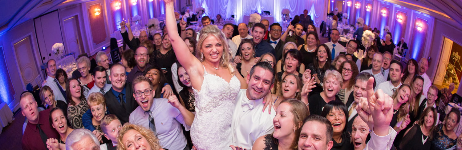 Happy wedding guests on the dance floor in Astoria Banquets