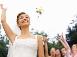 bride tossing up her bouquet